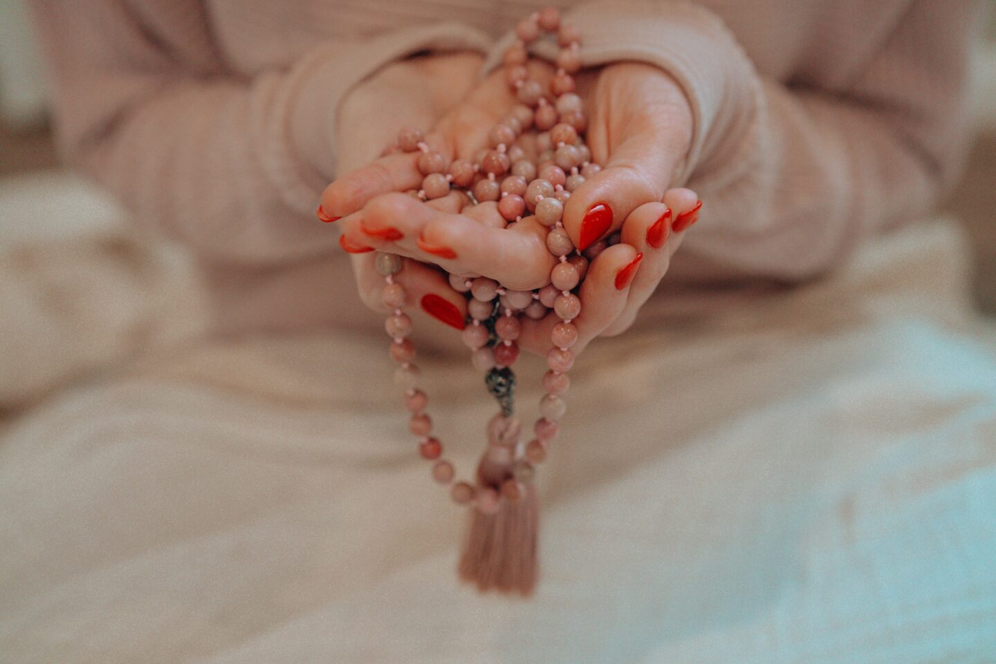 hands holding meditation beads