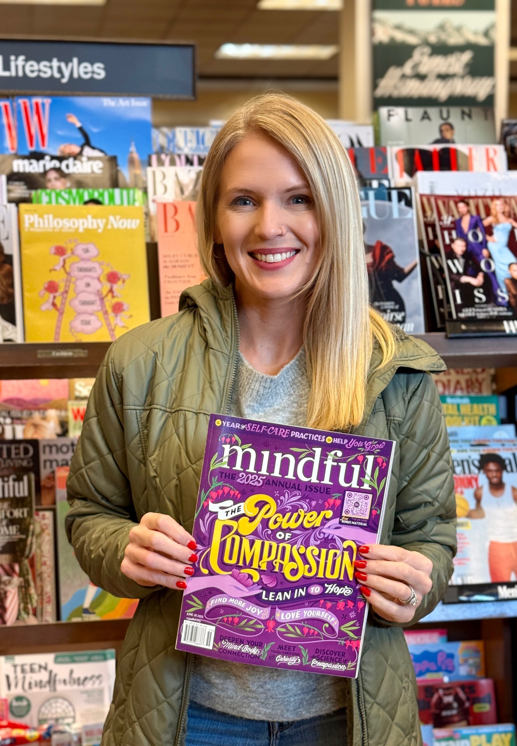 Woman holding a magazine titled "Mindful"